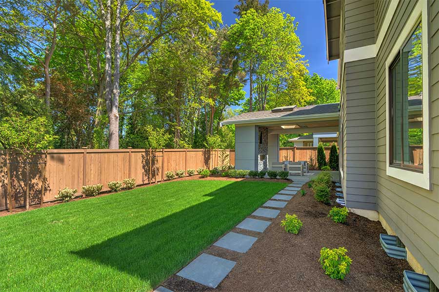 beautiful view of housebackyard with wooden fence