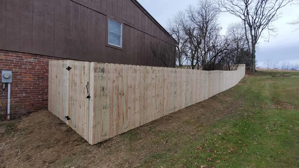 wooden fence on side of brown building aliquippa pa 1024x576 1